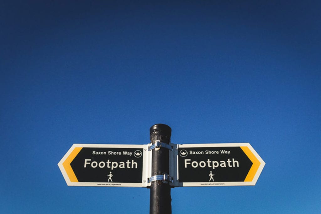 A footpath sign pointing the way to the Saxon Shore Way at Seasalter in Kent, photographed by Simon Hawkins Pictures